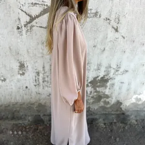 Close-up detail view of a loose pink lantern sleeve dress with soft fabric texture.