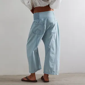 Back view of women's light blue washed denim harem pants with drop crotch and wide leg