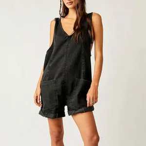 Detail view of washed black denim short romper with large front pockets and V-neckline
