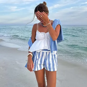 Close-up of blue striped beach shorts for women in a summer coastal beach setting