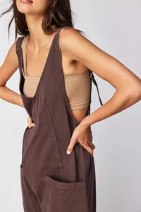 Close-up detail view of dark brown V-neck denim overalls with adjustable straps