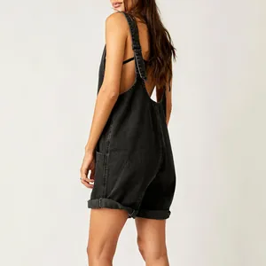 Back view of trendy black washed denim overalls shorts with adjustable straps for women.