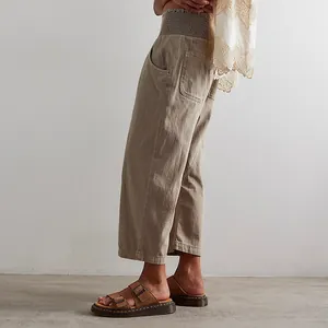 Detailed side view of women's vintage washed khaki harem jeans with large pockets.