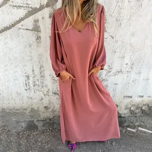Detail of loose V-neck maxi dress with lantern sleeves and side pockets in dusty rose