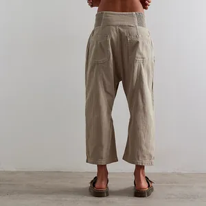Detail view showing the back pockets and drop-crotch of women's khaki harem denim pants