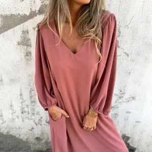 Close-up detail of the elegant V-neckline and lantern sleeves on this mauve casual dress
