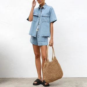 Model wearing casual loose short-sleeve denim shirt and matching shorts two-piece set