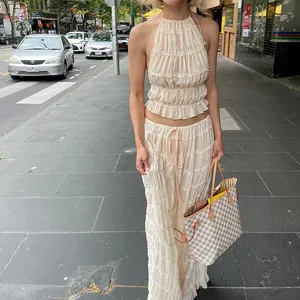 Élégant ensemble beige plissé avec haut dos nu et jupe longue assortie style vacances