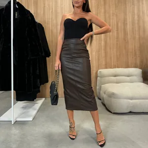 Full-body view showing the slim fit and texture of a brown high waist PU leather midi skirt.