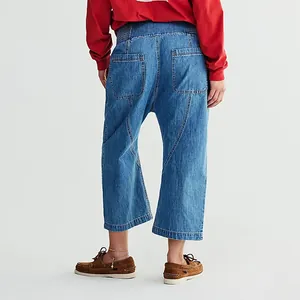Detailed back view of women's blue washed denim dropped crotch cropped harem jeans