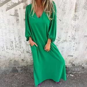 Detailed visual of a vibrant green V-neck maxi dress featuring elegant lantern sleeves