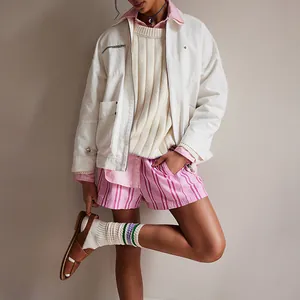 Detail view of pink and white striped beach shorts with elastic waist and side pockets