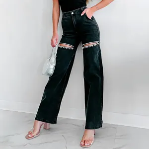 Detail of black straight leg jeans featuring rhinestone-embellished thigh cut-outs