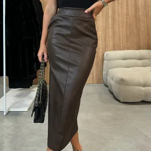 Detail of high-waisted brown faux leather midi skirt with chic slit and slim fit