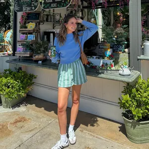 Casual green and white striped shorts for women in a summery lifestyle setting