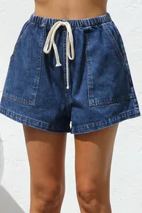 Close-up of casual denim shorts featuring elastic waist, drawstring, and large pockets.