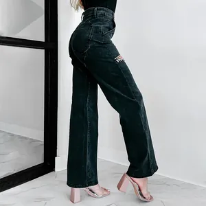 Detail view of high-waist black wide-leg jeans with rhinestone embellished thigh cutout
