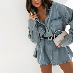 Detailed shot of a vintage light blue oversized denim shirt featuring large chest pockets.