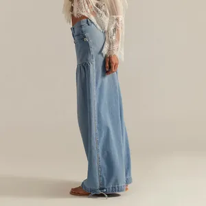 Side view of women's washed blue wide-leg jeans with unique drawstring hem detail.