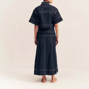 Back view of dark indigo denim two-piece set with elegant white contrast topstitching