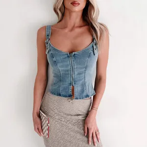 Close-up detail of stylish blue denim corset top featuring front zipper and buckle straps