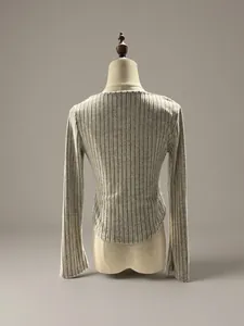 Back view of a slim fit ribbed long sleeve t-shirt with curved hem on mannequin.