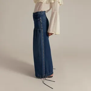 Side view of loose denim jeans with drawstring hem and pocket detail