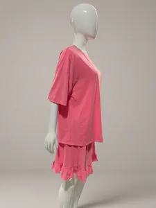 Side view of comfortable women's pink loose short sleeve T-shirt and ruffled pajama set.