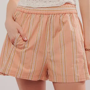 Close-up detail of peach striped casual shorts with elastic waist and side pocket