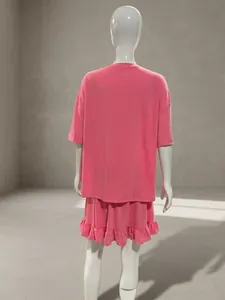 Detailed back view of pink two-piece casual lounge set featuring a ruffled hem skirt