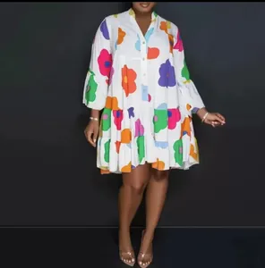 Full view of a colorful floral print loose mini dress with ruffled long sleeves.