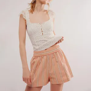 Detail view of orange striped summer beach shorts featuring a comfy elastic waist