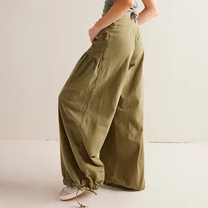 Side-back view of olive green wide-leg cargo pants with drawstring hem for women