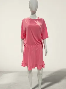 Detailed view of women's pink summer pajama set with short sleeve top and ruffle skirt