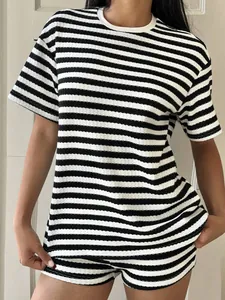 Detailed view of the black and white horizontal striped T-shirt and shorts set