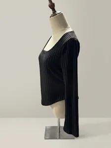 Detail view of black ribbed long-sleeved T-shirt with curved hem on mannequin