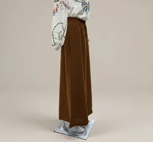 Side view of brown loose elastic waist wide leg pants on a mannequin