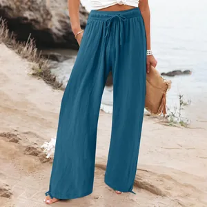 Comfortable light blue wide-leg casual trousers with drawstring waist for beach.