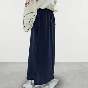 A detail shot of the navy blue loose wide-leg pants showing the comfortable elastic waist