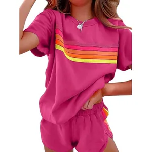 Women's pink loungewear set featuring vibrant rainbow stripes on T-shirt and shorts.