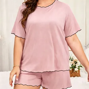 Two-piece pink loungewear set featuring black lettuce edge trim on sleeves and hem.