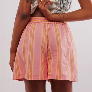 Back view of pink and orange striped cotton beach shorts with elastic waist.