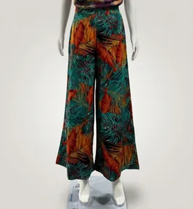 Detailed view showing the vibrant tropical leaf pattern on high-waisted wide-leg trousers