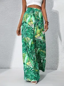 Stylish high-waisted wide-leg pants featuring a vibrant green tropical leaf print for summer
