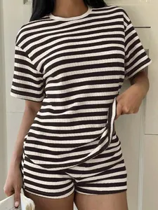 Detailed view of women's oversized striped waffle knit tee and shorts set on model