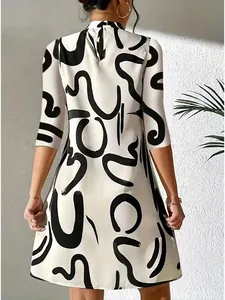 Back view of a stylish white midi dress featuring bold abstract black prints and 3/4 sleeves.