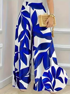 Detalle del vibrante estampado de hojas azules en elegantes pantalones anchos blancos de talle alto
