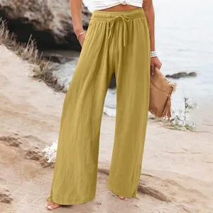 Detail view of mustard yellow wide-leg linen pants with elastic drawstring waist