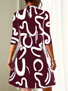 Detailed back view of a burgundy fashion dress featuring bold white abstract line prints