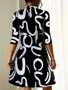 Detailed rear view of a black A-line dress featuring a unique white abstract swirl print pattern.